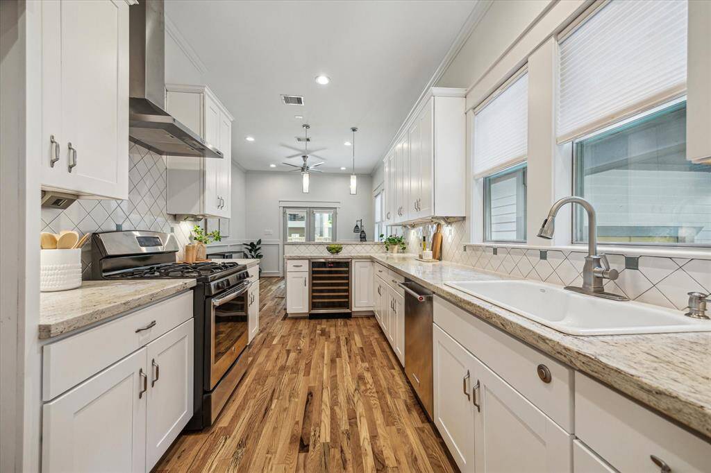 The heart of the home features a wine cooler and is open to the living spaces with views of the front and back.