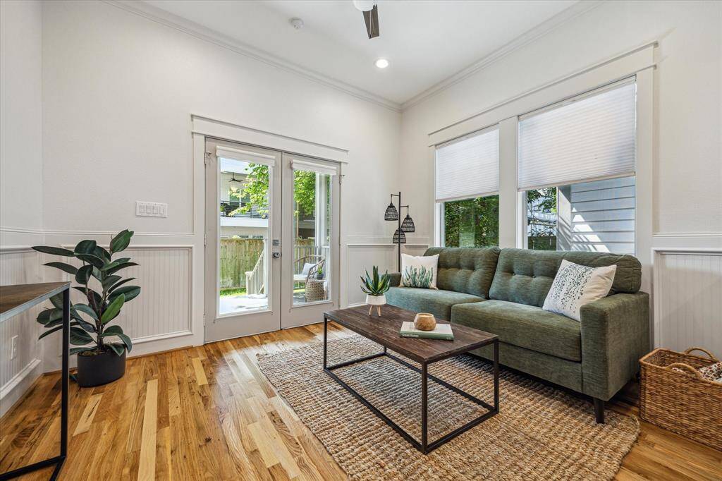 This inviting family room features double doors that open to the backyard - perfect for easy access to outdoor dining, entertaining or play.