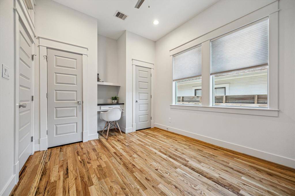 Secondary bedroom with dual closets and built in desk - perfect for work, study or creative projects