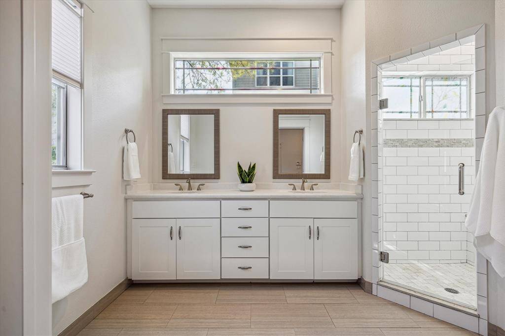 The primary bedroom suite features dual sinks and plenty of drawers.