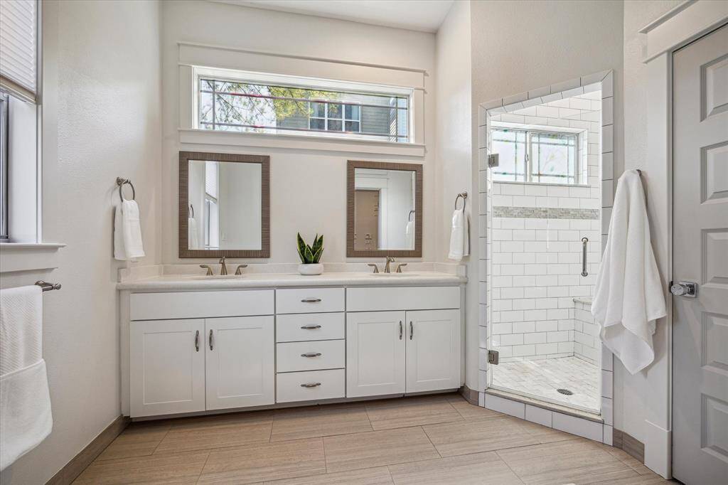 There is plenty of space in the primary full bath and tons on sunlight.