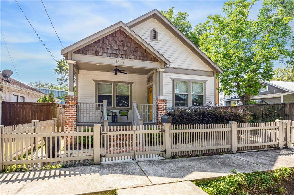 Picket, fence and adorable front porch create irresistible curb appeal