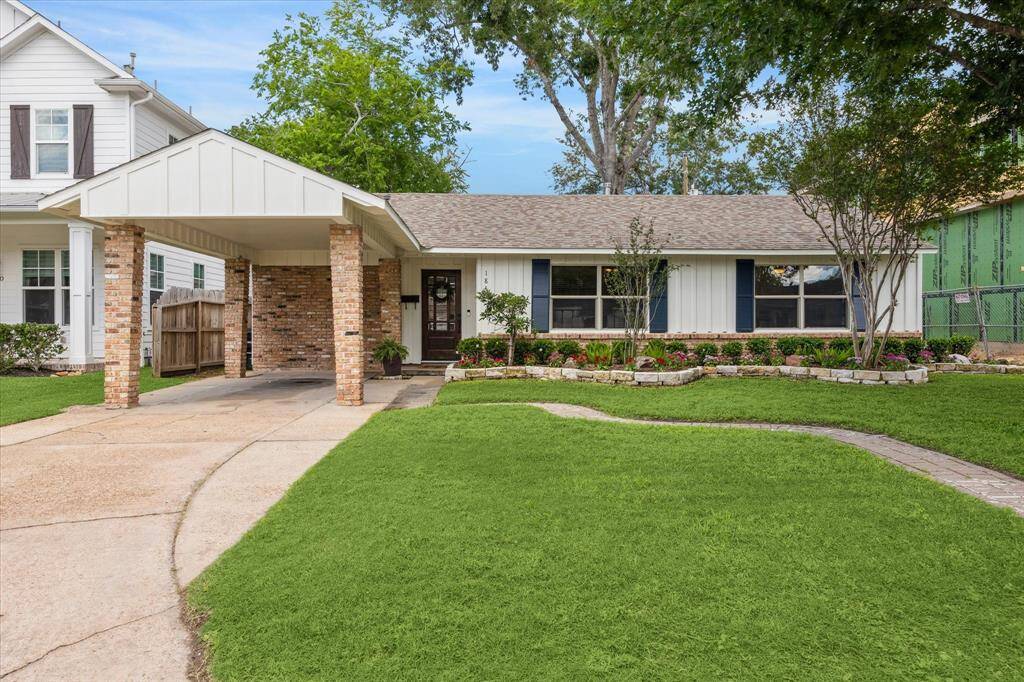 Curb appeal shines at 1846 Chantilly with charming brickwork, classic board-and-batten siding, and fresh landscaping that enhances the home's welcoming presence. A covered carport with architectural detailing adds both function and character to this inviting façade.