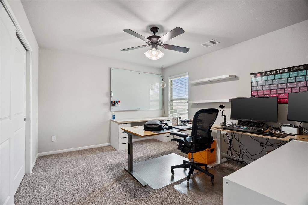 Third bedroom features awindow and plush carpet.