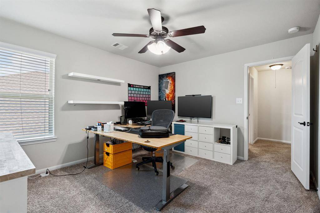 Third bedroom features awindow and plush carpet.