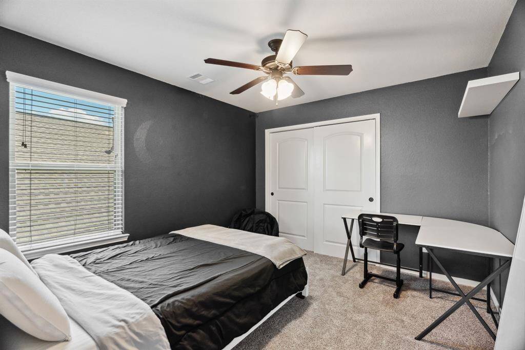 Fourth bedroom features awindow, custom paint, and plush carpet.