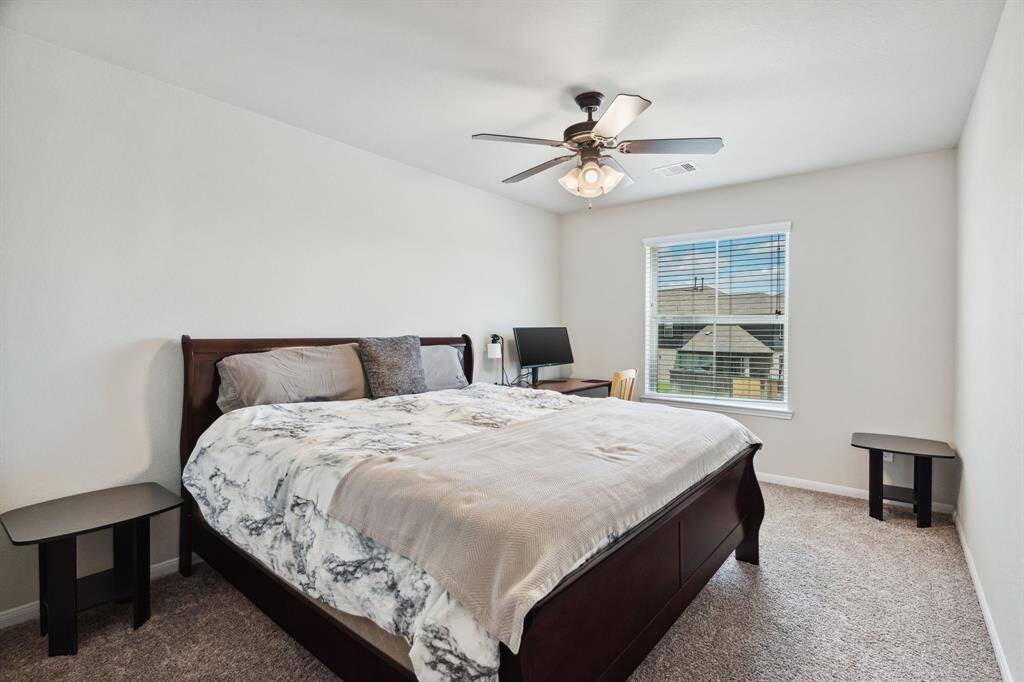 Sixth bedroom is also a flex room and featuring awindow and plush carpet.