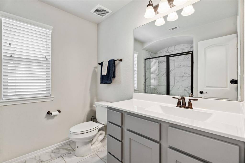 Secondary bathroom features a shower and vanitywith plenty of counter space.