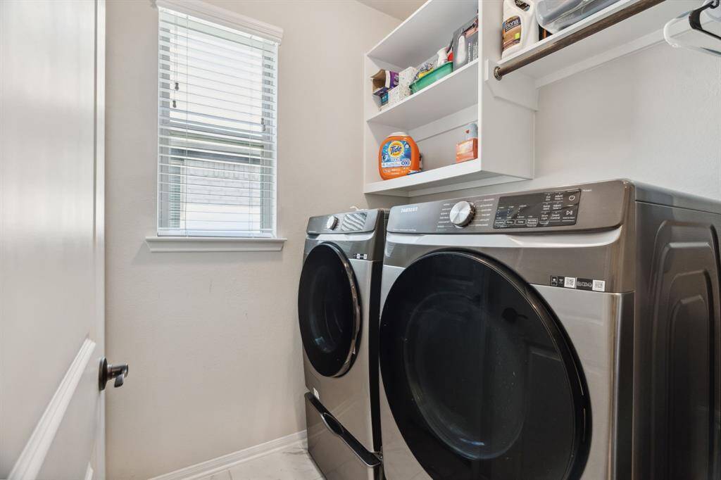 The laundry room features tile floors,washer and dryer connections, andplenty of storage space.