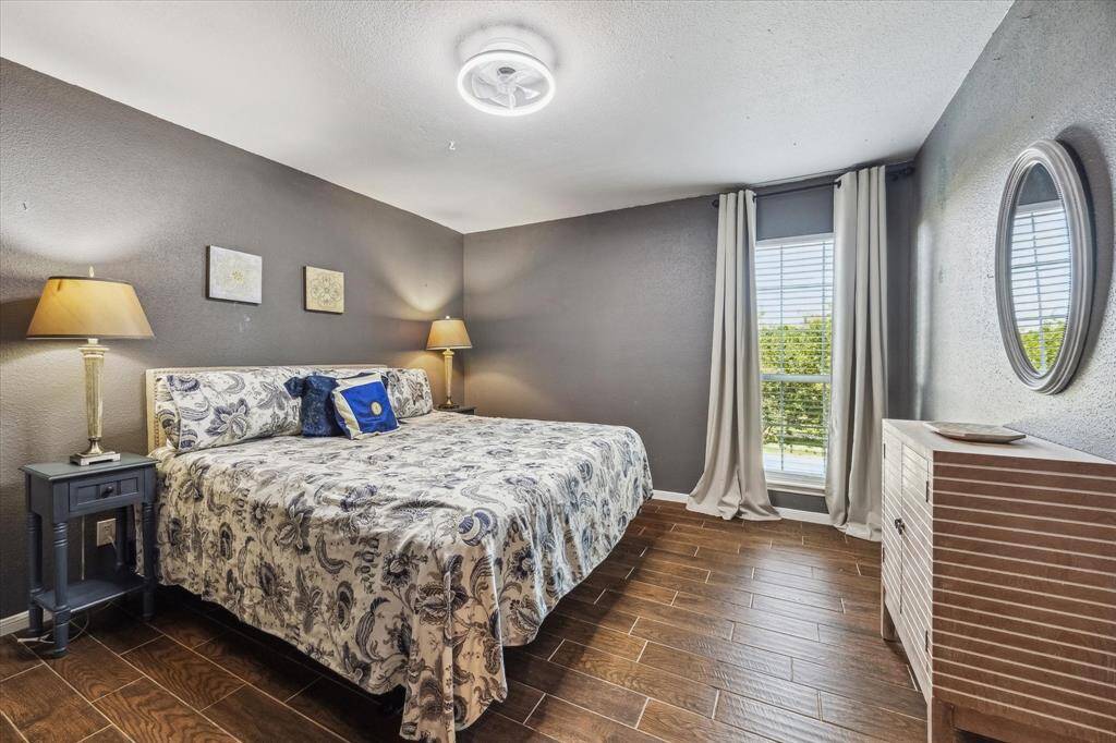 You’ll have sweet dreams in this posh retreat, featuring sleek wood-look tile flooring, fresh designer paint, and a modern 6-speed ceiling fan with light. A roomy walk-in closet keeps everything organized, and convenient access to the full bathroom adds everyday ease.