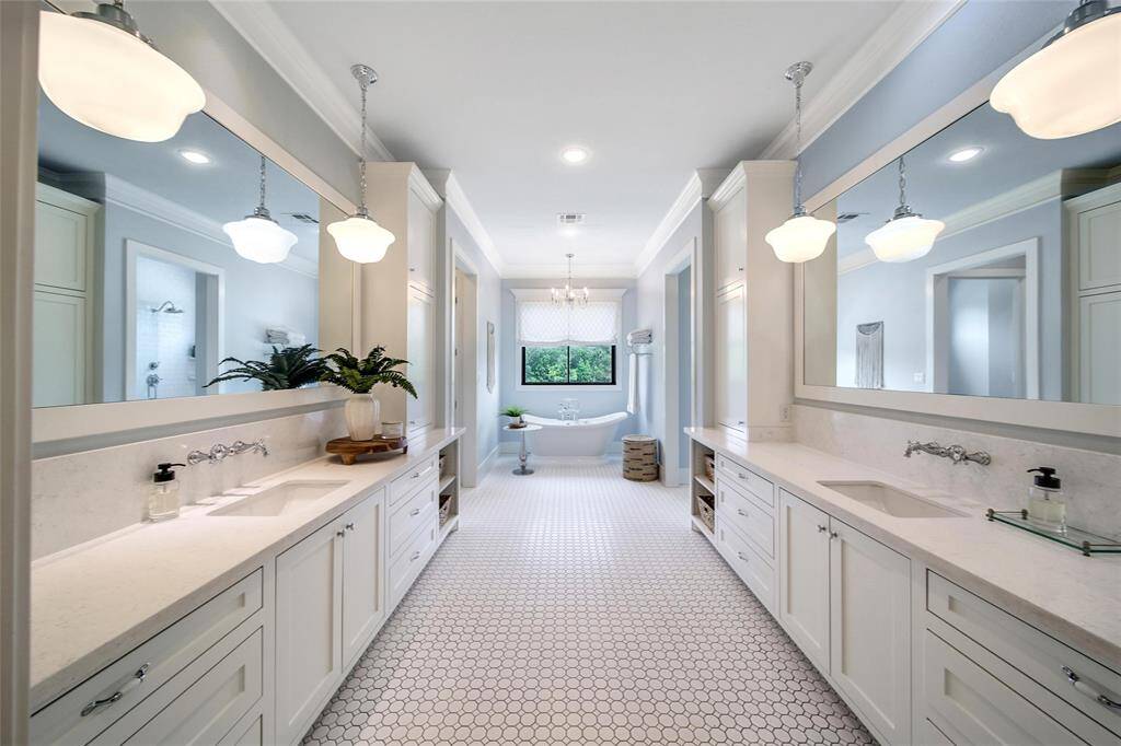 His & her sinks and his & her closets (including stacked washer and dryer) in the master bathroom