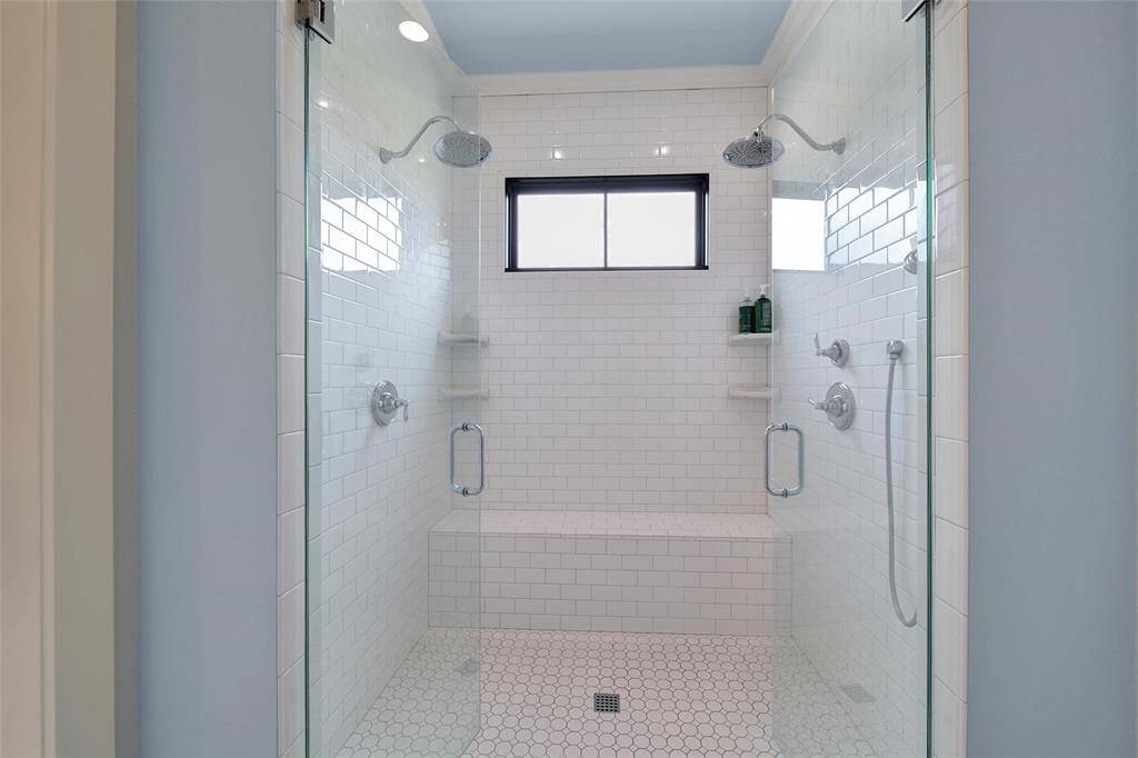 Huge walk-in shower with dual spray heads and large bench