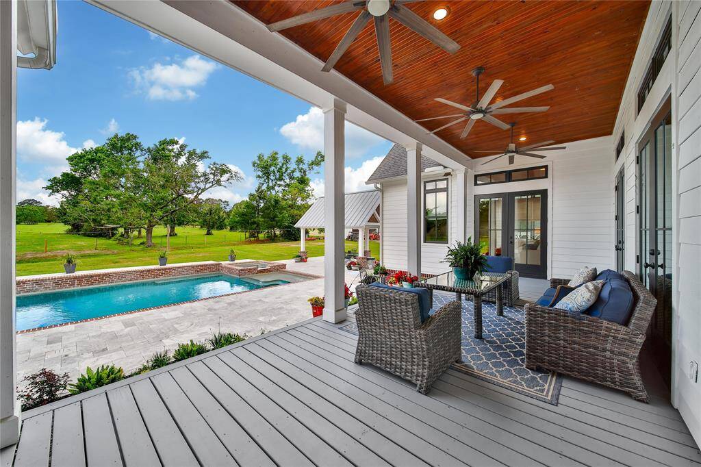 Back porch overlooking pool/spa and neighbors longhorn pasture