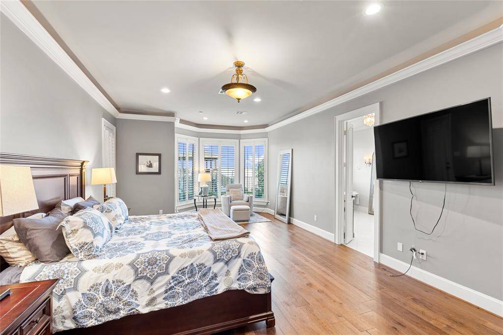 The Primary suite....wood floors, plantation shutters, a sitting area and just wait for the bathroom....