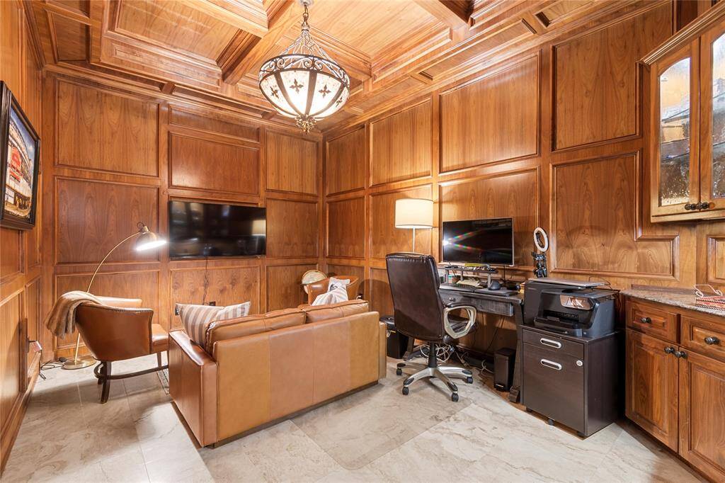 Adjacent to the primary bedroom, tucked out of the way you will find your custom paneled office.