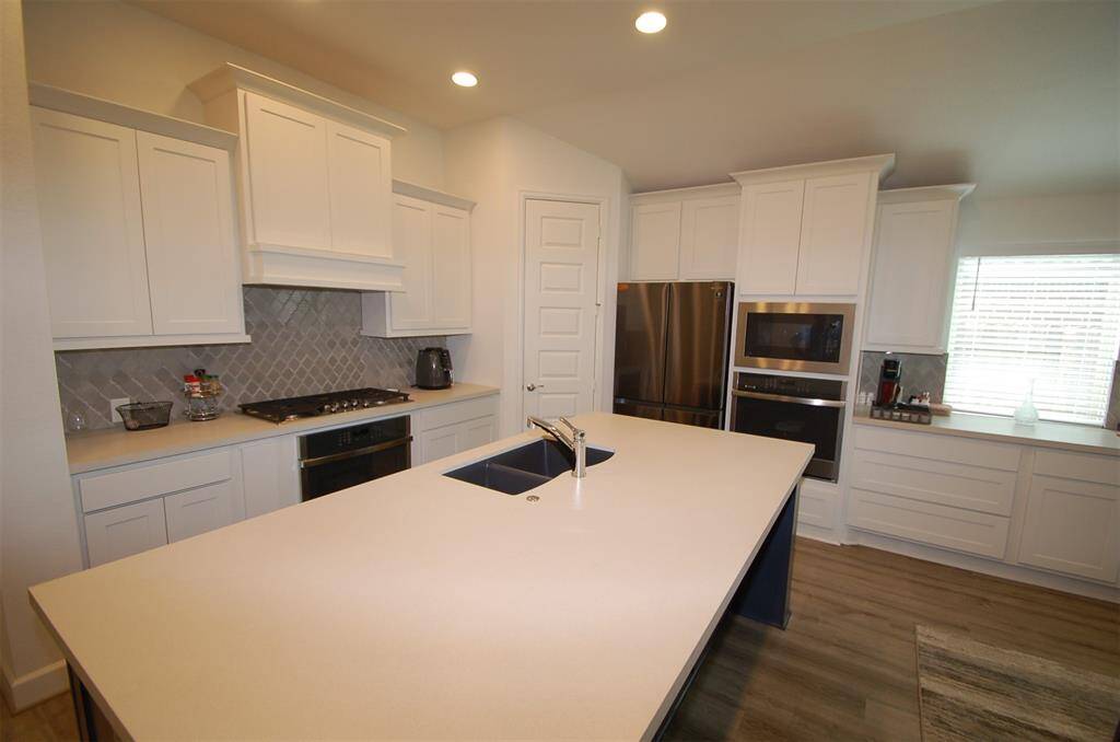 Open Kitchen with engineered stone-Patina counters.
