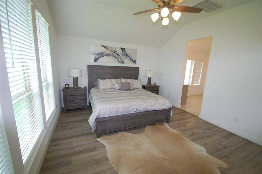 Primary bed room has wall of windows over looking the back yard.