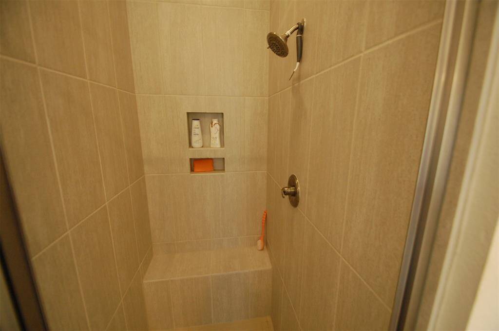 Primary shower has a seat when the wife wants to shave her legs.