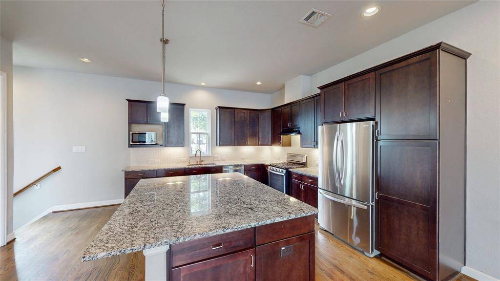 This beautiful kitchen offers a stylish and functional space for cooking and entertaining.  The oversized island has ample space for multiple barstools and under counter storage.