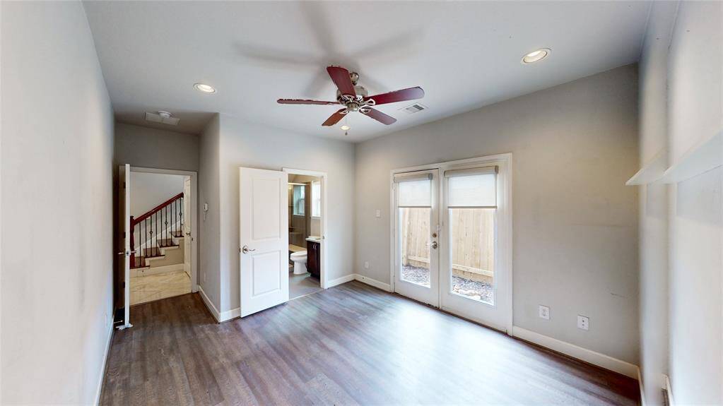 This room features Luxury Vinyl Plank flooring, recessed lighting and an En-suite bathroom. French doors lead to a small outdoor space.