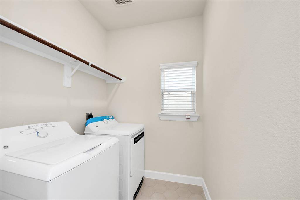 Tucked conveniently near the main living areas, this utility room offers space for a full-size washer and dryer. Clean, functional, and designed to simplify laundry day.