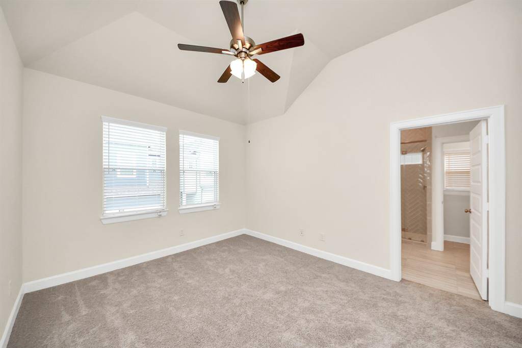 This angle showcases the spacious feel of the primary suite, enhanced by tall ceilings, double windows for natural light, and direct access to your private, spa-inspired bathroom. It’s a serene space that invites you to unwind.