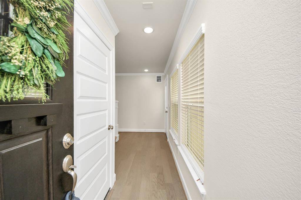 Step In. Breathe Out. - From the moment you open the door, you’re greeted by clean lines, natural light, and warm wood floors that create a fresh and inviting first impression. This entryway sets the tone for the rest of the home—modern, bright, and thoughtfully designed for everyday comfort. Benefits: Crisp neutral palette; abundant windows for natural light; spacious entry perfect for personal touches and a stylish welcome to the life you’re building at 1918 Huntly Chase.