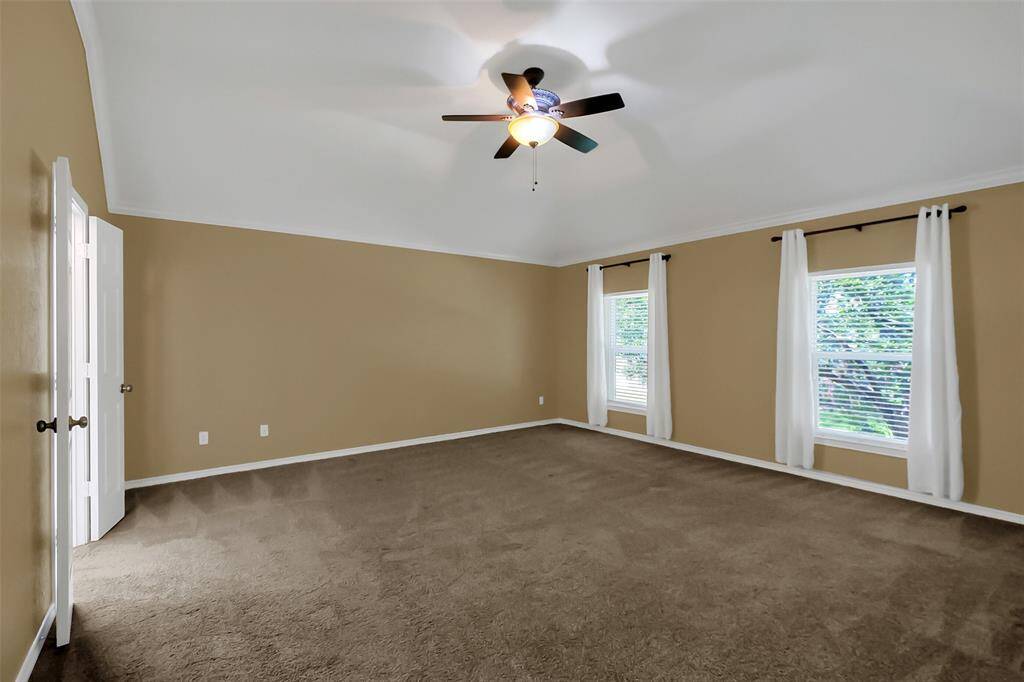 Large master bedroom located on second floor facing front of home.