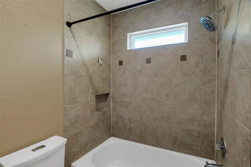 Separated shower/bathroom area.
