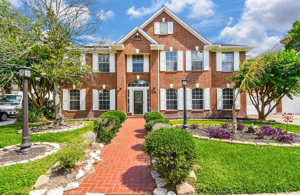 This is not just a spectacular home, but a true showplace, stealing every bit of curb appeal from neighboring homes! Meticulous care, inside and out, define this gem; with attached garages and wide driveway seen, right. Did you ever think you could be called Master or Mistress of the Manor? This 1994 treasure is located at 19711 Arbor Creek Drive, Katy, TX, in the lush Estates Highland Creek community.