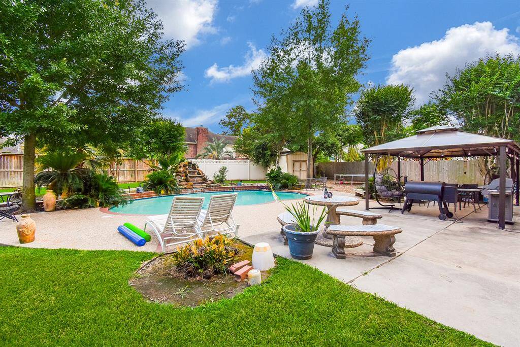 Exquisite natural greenery surrounds the back property, pool and patio for sublime outdoor pleasure.
