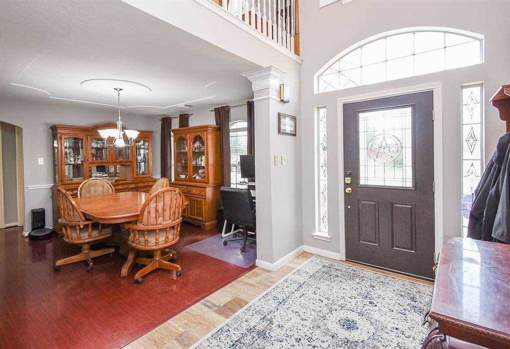 This front formal dining area, left, boasts rich engineered wood flooring, a delicate traditional chandelier and tons of wall/floor space for your treasured pieces.