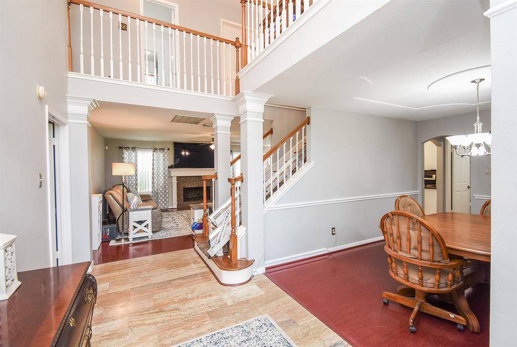 The visual beauty and physical benefits of the open floor plan design concept is clearly appreciated here, in this view from the entry hallway, front room (right), and straight ahead to the living area.