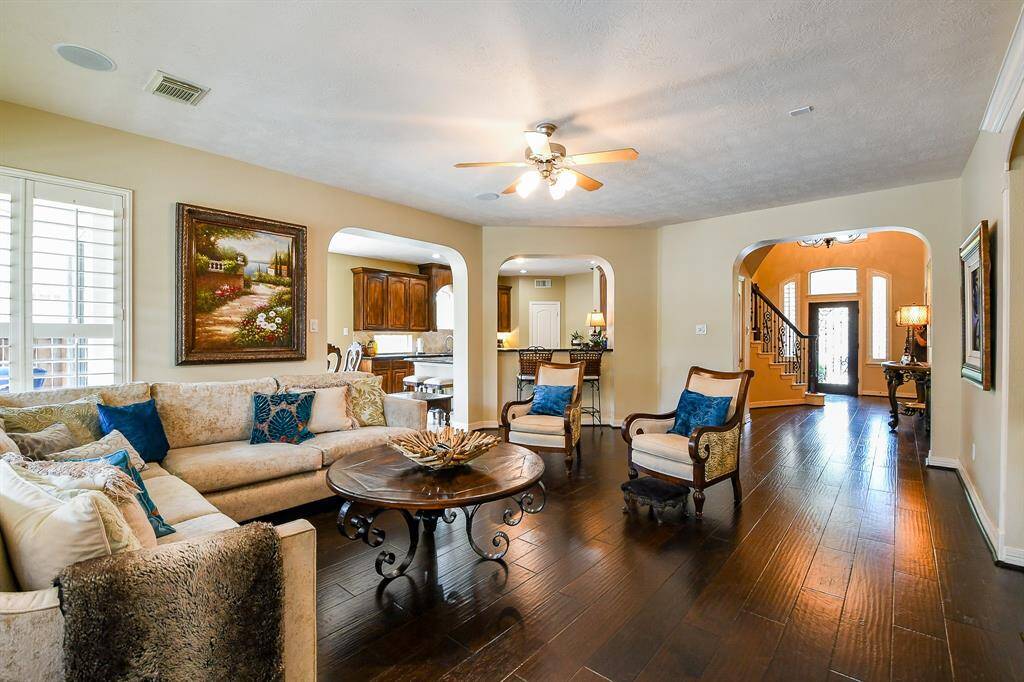 Another look at the family room.  Note the updated, neutral interior paint, in-ceiling speakers, and ceiling fan.  There is even a bar area pass-through from the den into the kitchen!