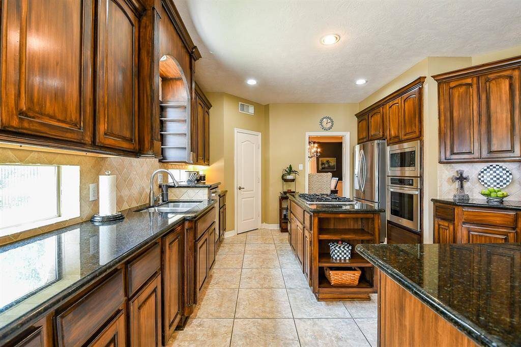 The kitchen is everything you hoped for and more.   The cabinets afford TONS of storage space, and you will love the enormous walk-in pantry (straight ahead on left).