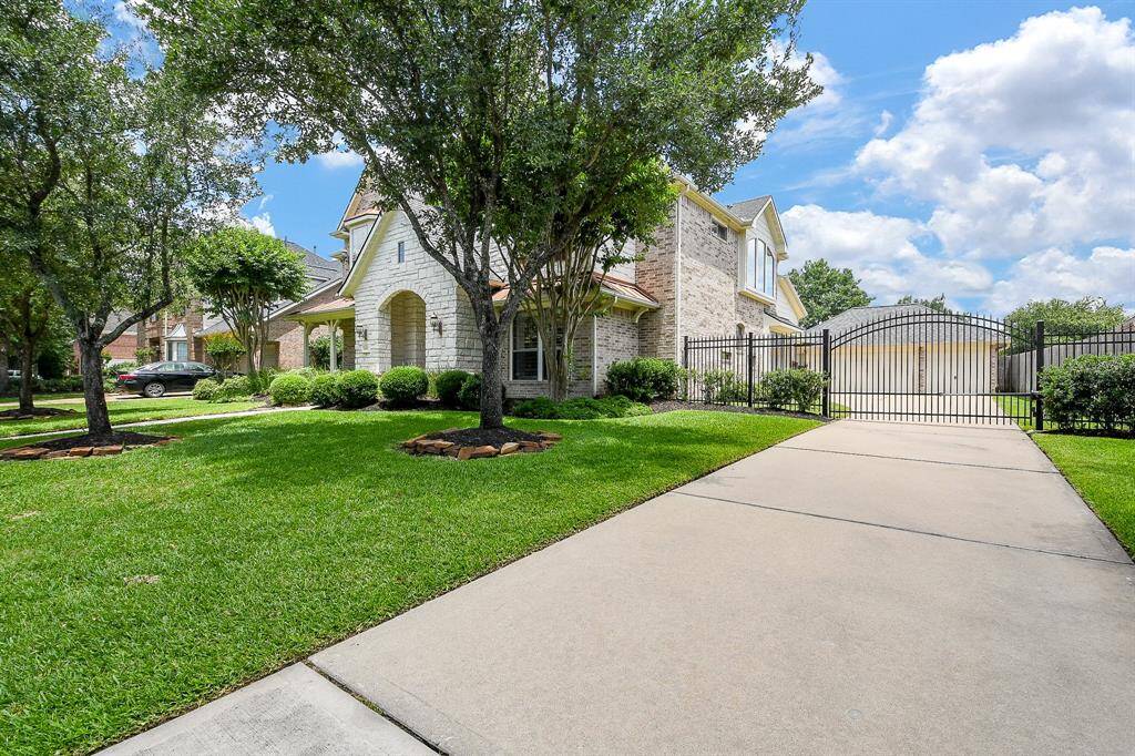 Private automatic driveway gate affords extra security. Double wide drive leads to 3 car detached garage with built-ins and excellent storage space.