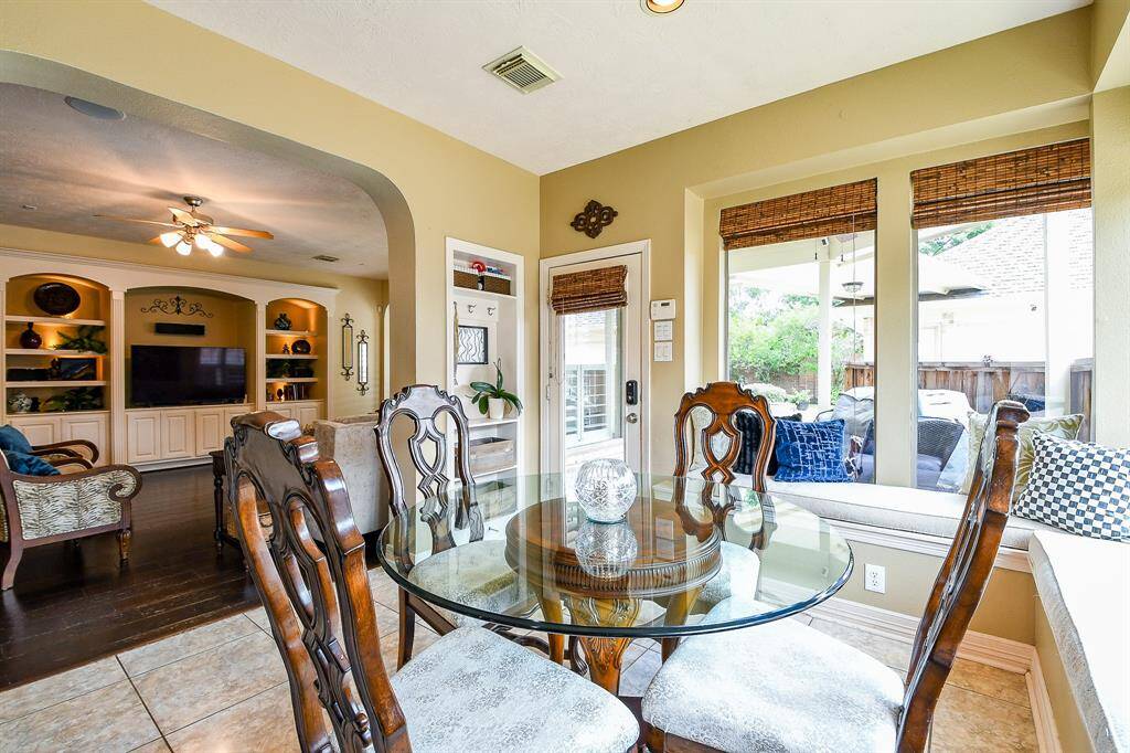 There is even custom bench seating along two walls in the breakfast area.  The wood woven shades are an excellent way to bring a natural, earthy aesthetic into the home.