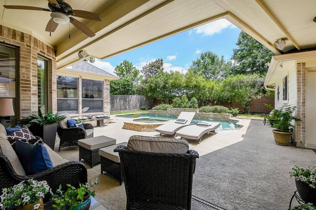 Let's take a look at the great outdoors!  The covered patio overlooks the fabulous in-ground pool with hot tub & waterfall.
