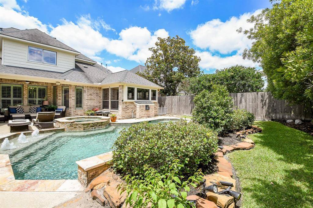 There is fantastic landscaping, including landscape lighting, around and behind the pool.   Not shown here but there are cross-pool sprayers also, which will add to your summertime fun!