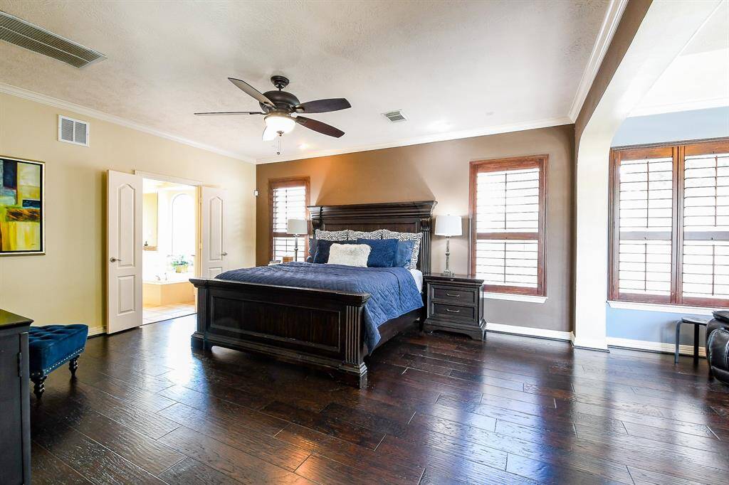 The primary bedroom is wonderfully oversized and can accommodate all of your furniture.  To the right is a cozy sitting room with fireplace (which would make for a great reading area, or the perfect newborn nursery area!).  To the left is the master bathroom.