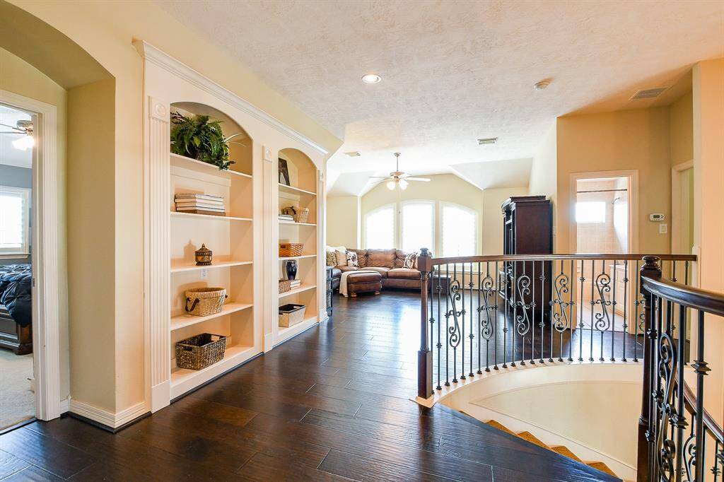 This is your view from the top of the stairs!  You will appreciate the functional layout this home offers.  There are 4 secondary bedrooms, 3 full baths, a game room, and a little office or study nook on this floor.  The built-ins at the top of the stairs are perfect for displaying your prized possessions!