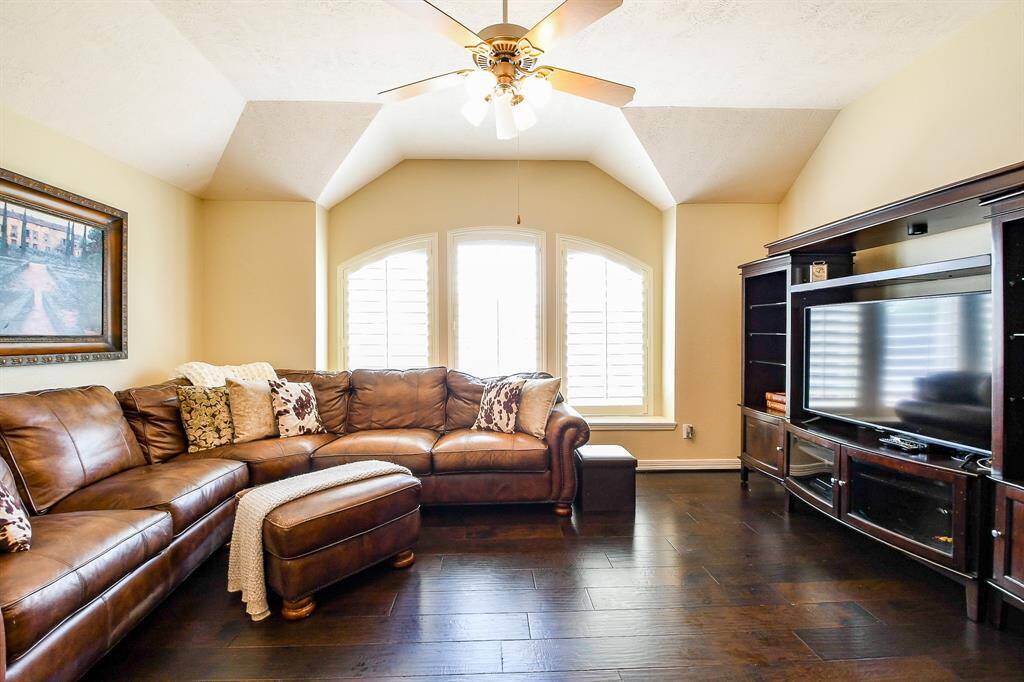 The game room features vaulted ceilings and 3 large windows with plantation shutters.  The furniture piece on the right (holding the TV) is negotiable, per Seller.