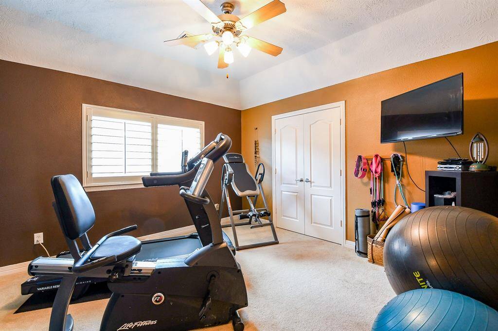 This bedroom is directly behind the office/study nook, and the Sellers are currently using it as a work-out room.  There is a large closet in this room, and a ceiling fan. There is also a large window with plantation shutters.