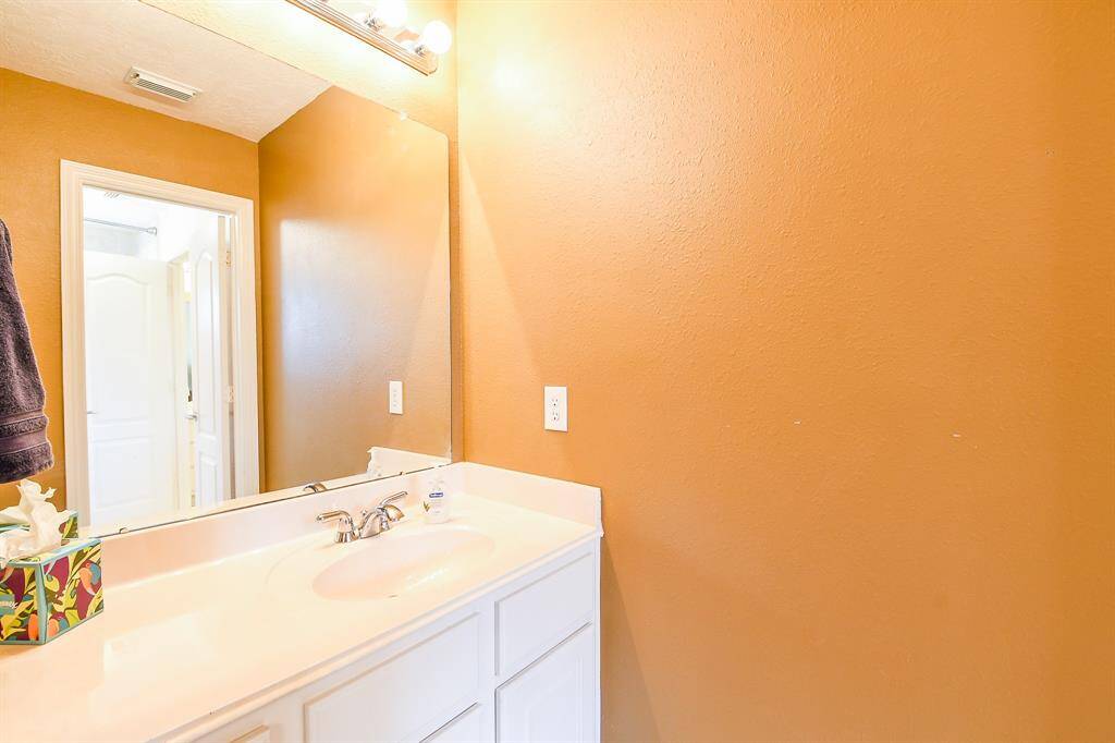 The bedroom in the preceeding picture shares a Jack & Jill type bath with the bedroom in the next photo.  Each bedroom has a private vanity area as shown here, and share a separate tub/toilet area.