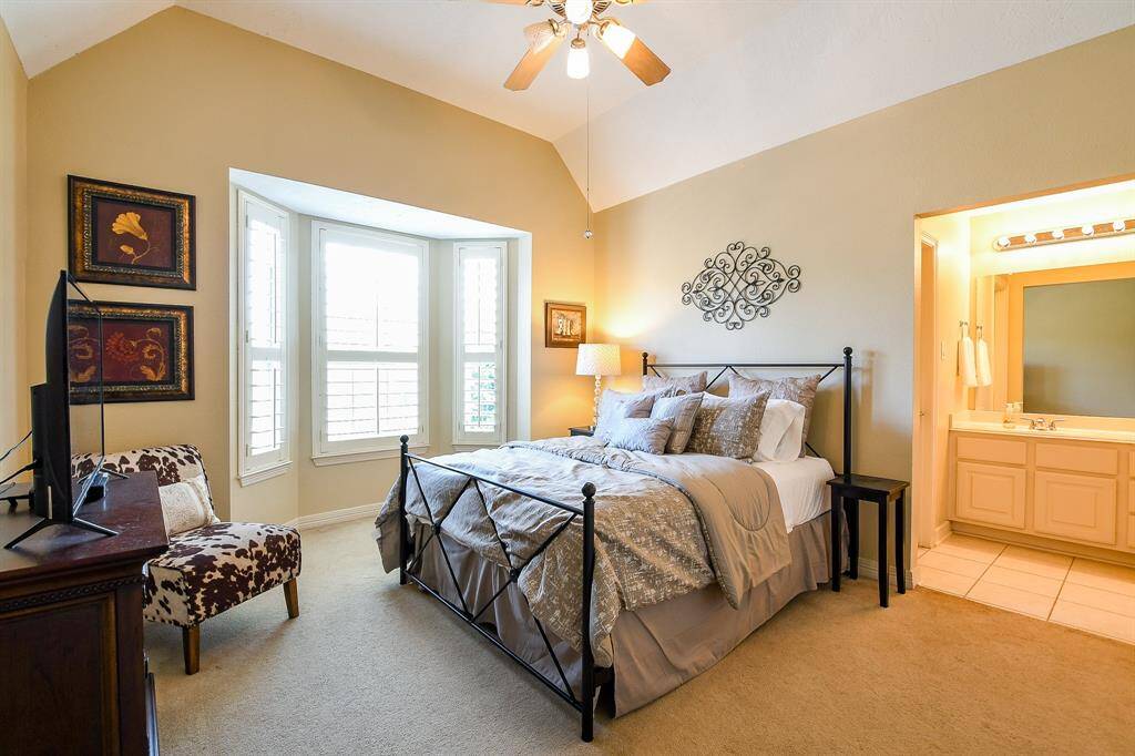 This is the bedroom which shares the Jack & Jill style bathroom.  Note the high ceilings, ceiling fan, beautiful bay window w/ plantation shutters.  This bedroom also has a large walk-in closet.
