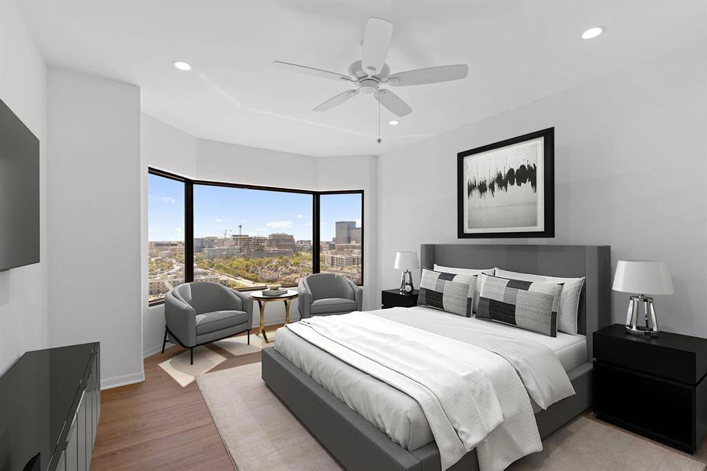 Primary bedroom with luxury vinyl floors, recessed lighting and ceiling fan. Image shown virtually staged.