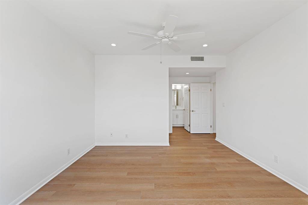Primary suite leading to the bathroom and walk-in closet.