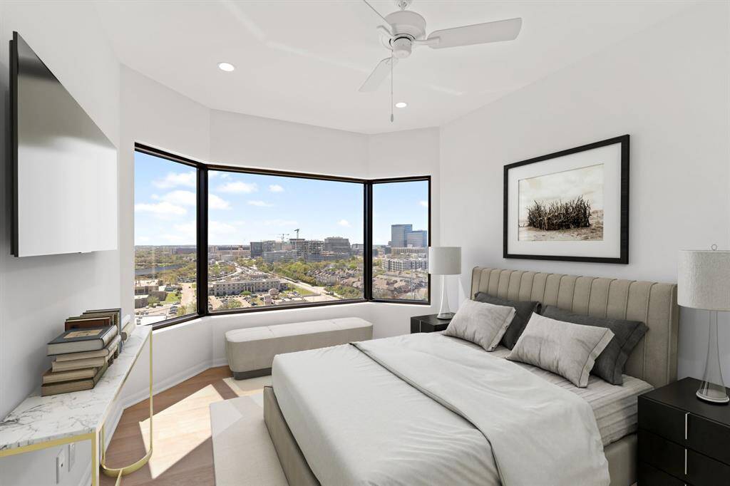 Second bedroom with luxury vinyl floors, recessed lighting and ceiling fan. Image shown virtually staged.