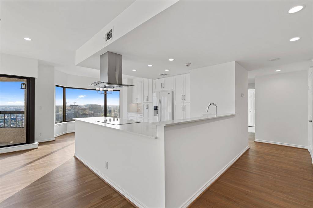 View of the entry open to the living and kitchen.