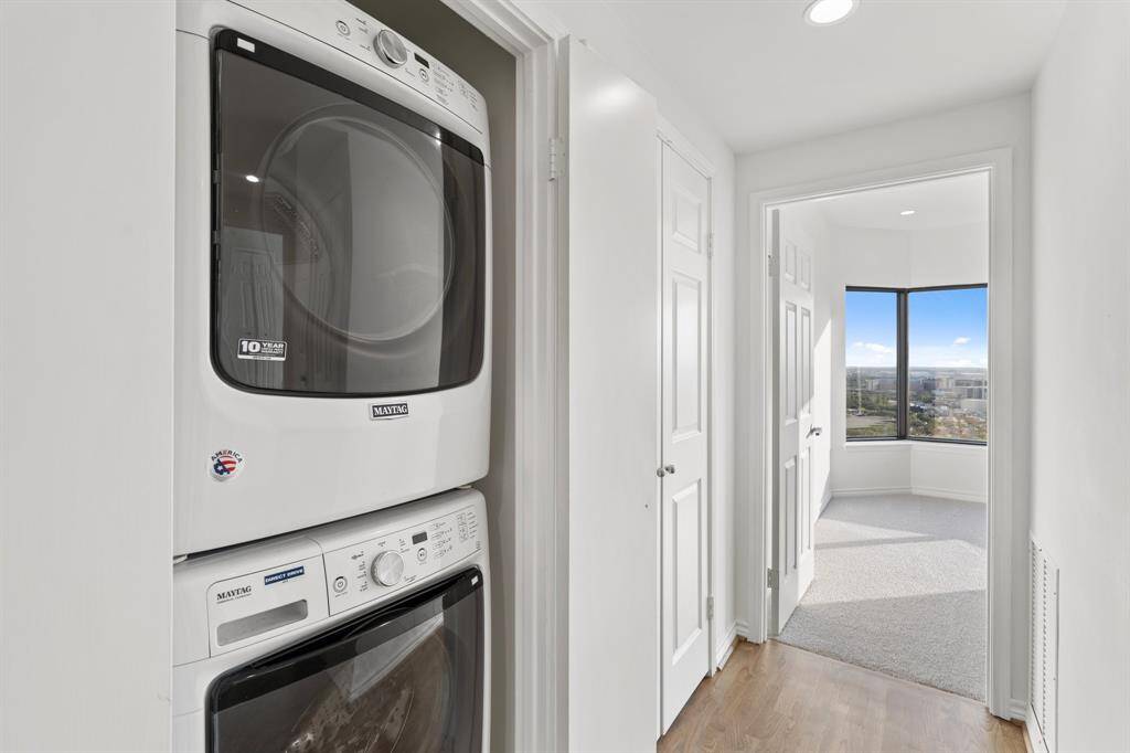 Washer/dryer with an additional shelved storage closet.